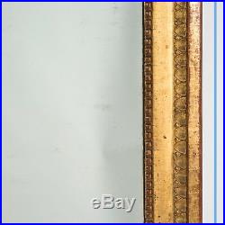 Miroir style Louis XVI en bois et stuc doré, XIXe