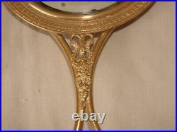 Miroir style Louis XVI en bronze doré et glace biseautée