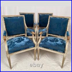 Suite de quatre fauteuils de style Louis XVI, bois laqué blanc et velours bleu